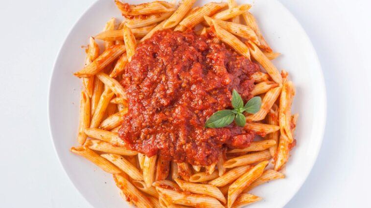 Penne all'Arrabbiata: Italian pasta with fiery tomato sauce, garlic, red chili peppers, and olive oil. A classic, bold dish.
